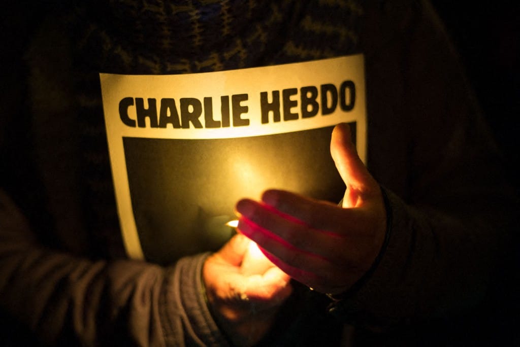People take part in a vigil in Place de la Republique, Paris, France, Wednesday January 7, 2015, after a deadly terror attack on French satirical magazine Charlie Hebdo . VOISIN/PHANIE (Photo by VOISIN / Phanie / Phanie via AFP)