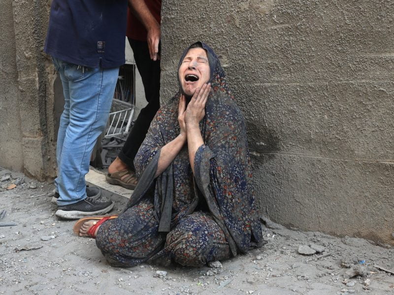 A Palestinian woman reacts after an Israeli airstrike on the Rafah refugee camp, in the southern Gaza Strip on October 17, 2023. Relief convoys which have been waiting for days in Egypt were on October 17, headed towards the Rafah border crossing with the besieged Palestinian enclave of Gaza, aid officials said.