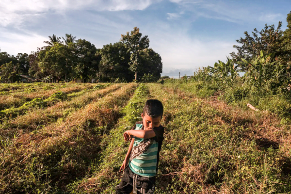 Exposure-adjusted New York Times of a child in a field in Venezuela