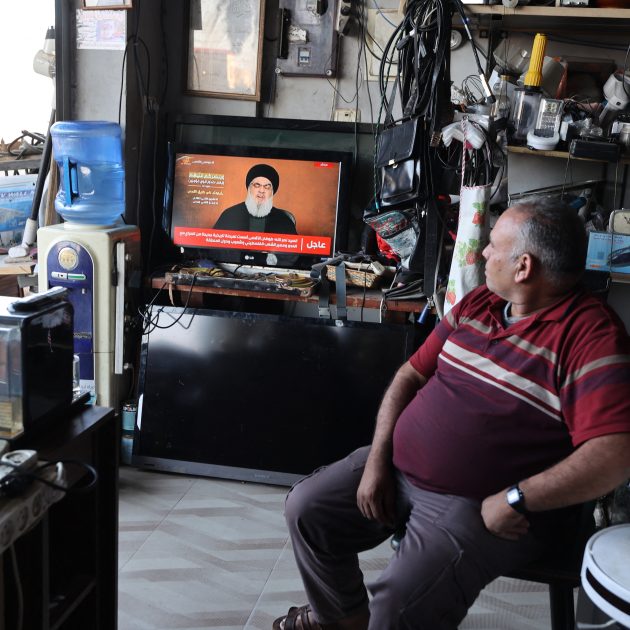 A man sitting in a shop watches the televised speech of Lebanon's Hezbollah chief Hasan Nasrallah, in the occupied West Bank town of Tubas on November 3, 2023. - Nasrallah on November 3 spoke for the first time since war broke out between Hamas and Israel, in a speech that could impact the region as the Gaza conflict rages. (Photo by Jaafar ASHTIYEH / AFP)