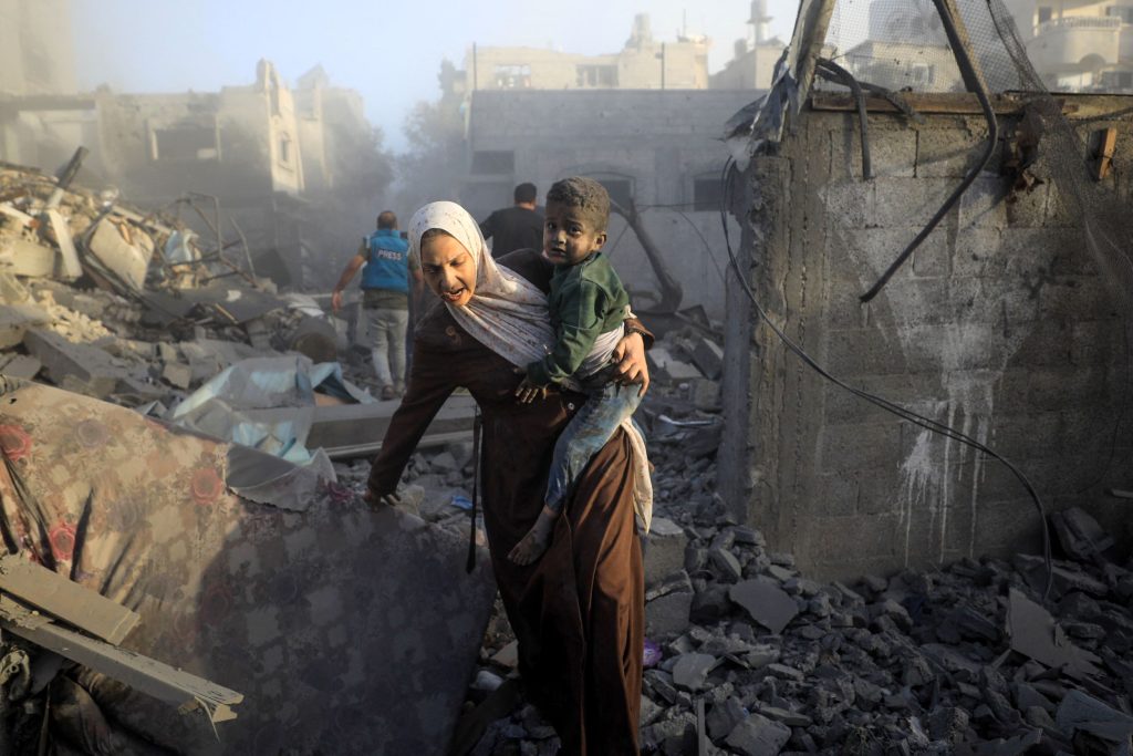 People flee following Israeli air strikes on a neighbourhood in the al-Maghazi refugee camp in the central Gaza Strip on November 6, 2023, amid ongoing battles between Israel and the Palestinian Hamas movement.