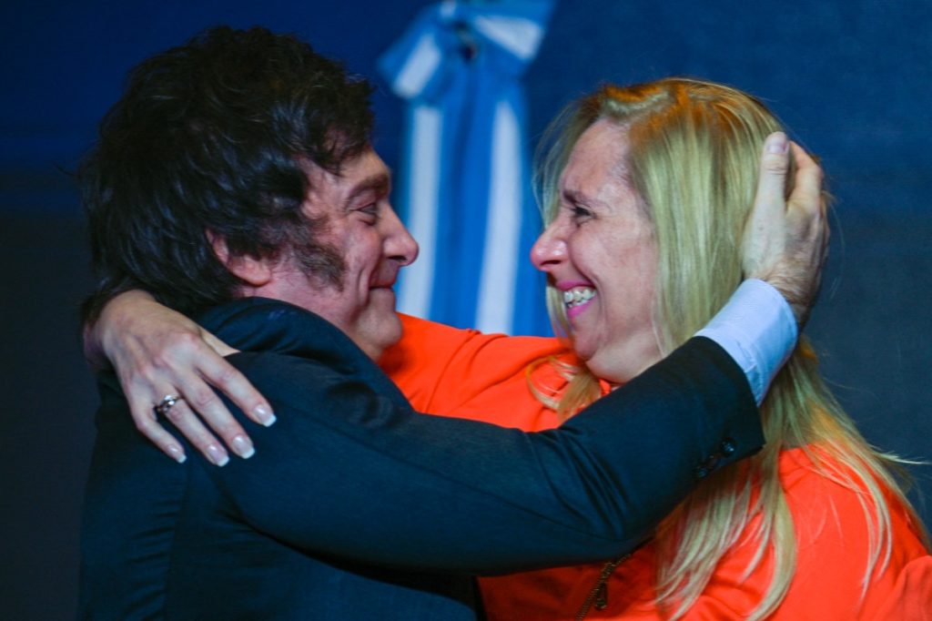 Argentine presidential candidate for the La Libertad Avanza alliance Javier Milei (L) celebrates with his sister Karina Milei after winning the presidential election runoff at his party headquarters in Buenos Aires on November 19, 2023. - Libertarian outsider Javier Milei pulled off a massive upset Sunday with a resounding win in Argentina's presidential election, a stinging rebuke of the traditional parties that have overseen decades of economic decline. (Photo by LUIS ROBAYO / AFP)