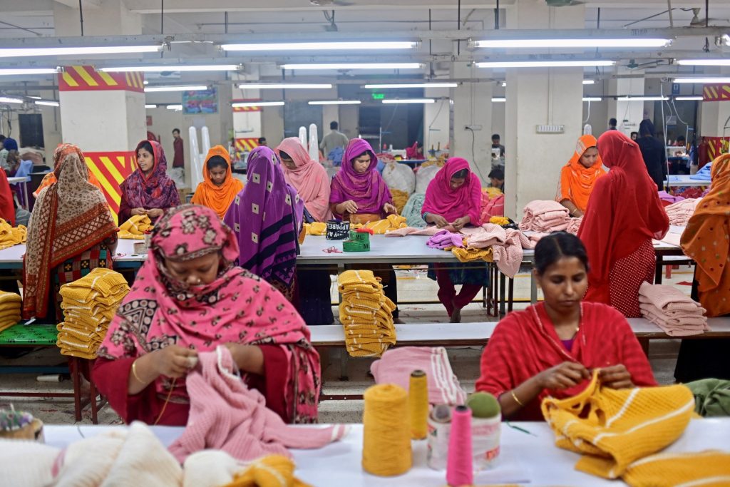 In this photograph taken on April 13, 2023, women work at a garment factory in Savar, on the outskirts of Dhaka. The tenth anniversary of the Rana Plaza garment building collapse will be marked on April 24, a catastrophe that spotlighted the global fashion industry's reliance on developing world labour, working in dangerous and sometimes deadly conditions. (Photo by Munir uz ZAMAN / AFP) / TO GO WITH 'BANGLADESH-ACCIDENT-LABOUR-TEXTILE,FOCUS' BY SHAFIQUL ALAM - To go with 'BANGLADESH-ACCIDENT-LABOUR-TEXTILE,FOCUS' by Shafiqul ALAM