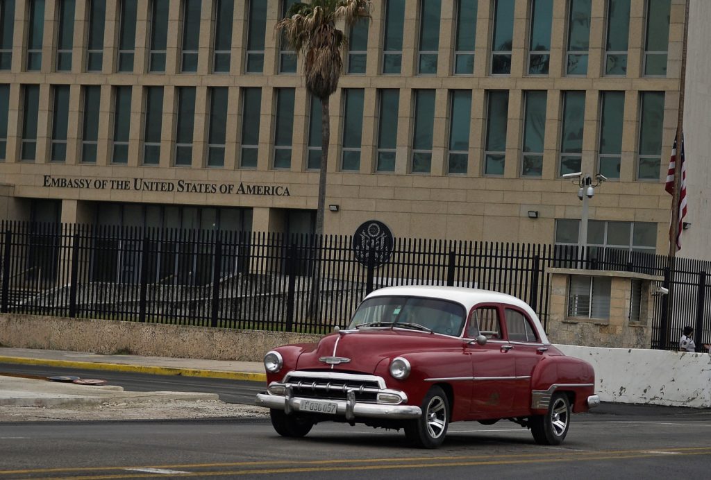 An old American car drives by the US Embassy of Havana, on January 12, 2021. Cuba's foreign affairs minister Bruno Rodriguez on Monday slammed the administration of US President Donald Trump for "political opportunism" for placing the country back on a blacklist of state sponsors of terrorism. (Photo by YAMIL LAGE / AFP)