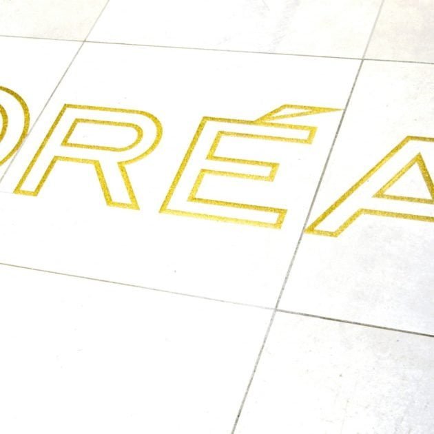 This photograph taken at the French cosmetic company 'L'Oreal' on November 17, 2022, shows the logo of L'Oreal on the floor at its production centre in Ormes, central France. (Photo by GUILLAUME SOUVANT / AFP)
