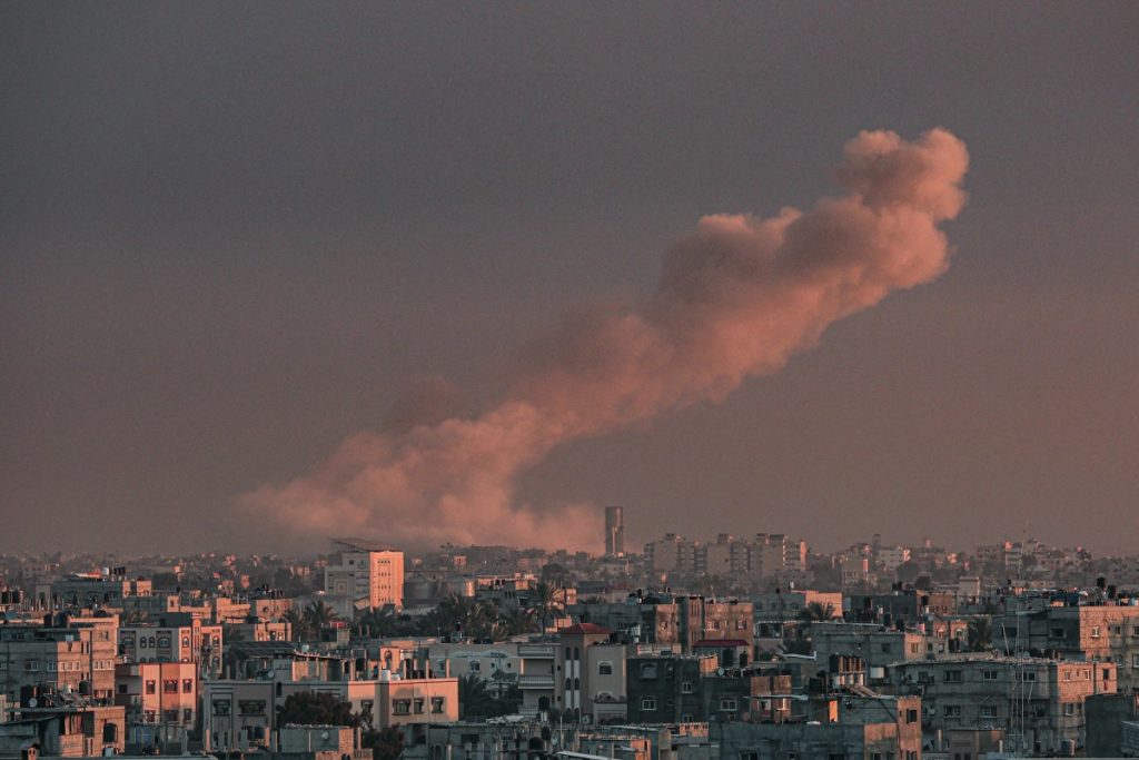 A picture taken from Rafah in the southern Gaza Strip shows smoke rising over buildings in Khan Yunis following Israeli bombardment on February 5, 2024, as fighting continues between Israel and the Palestinian Hamas group. (Photo by Said KHATIB / AFP)