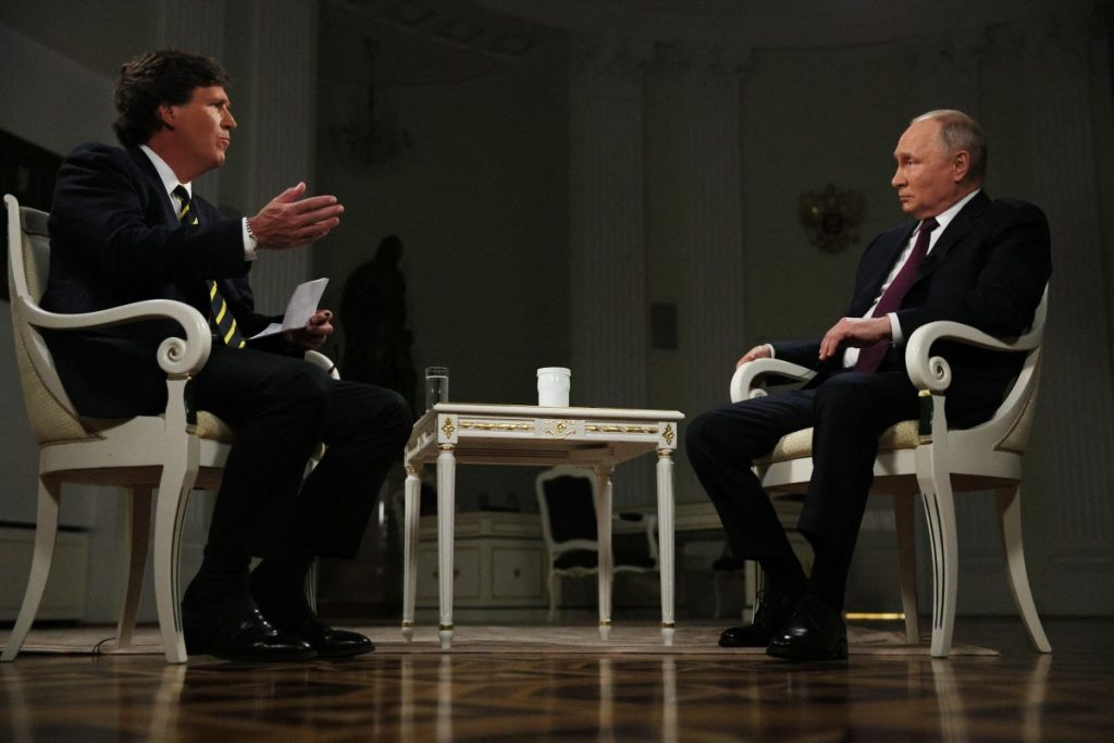In this pool photograph distributed by Russian state agency Sputnik, Russia's President Vladimir Putin gives an interview to US talk show host Tucker Carlson at the Kremlin in Moscow on February 6, 2024. (Photo by Gavriil GRIGOROV / POOL / AFP)