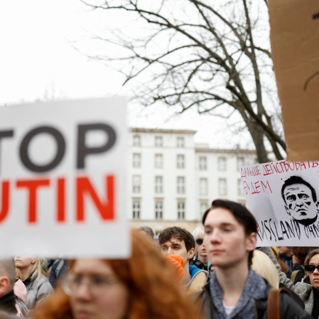 Protestors hold up placards, one which reads "We will go on" at a memorial on February 18, 2024 in front of the Russian embassy in Berlin, following the death of the Kremlin's most prominent critic Alexei Navalny in an Arctic prison. - Navalny's death after three years in detention and a poisoning which he blamed on the Kremlin deprives Russia's opposition of its figurehead at time of intense repression and Moscow's campaign in Ukraine. (Photo by Odd ANDERSEN / AFP)