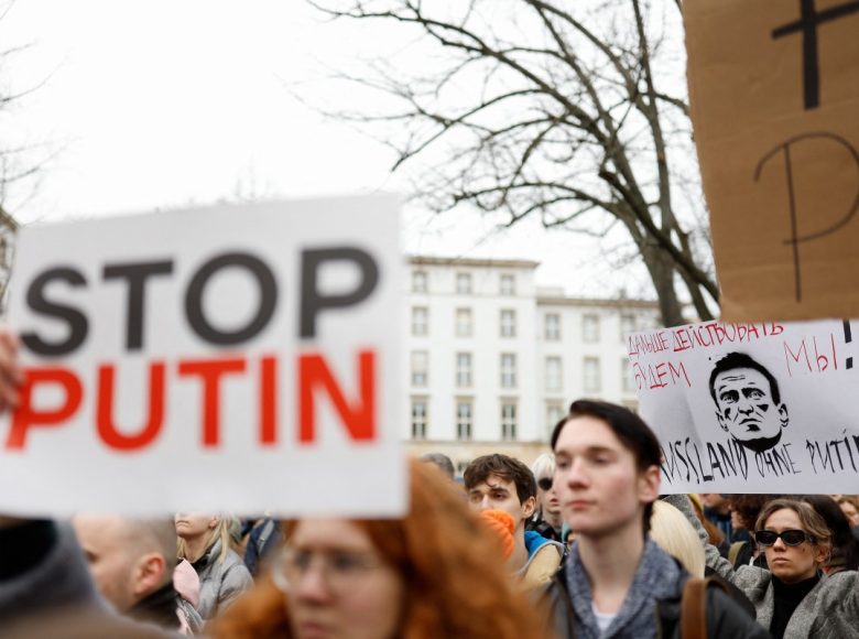 Protestors hold up placards, one which reads "We will go on" at a memorial on February 18, 2024 in front of the Russian embassy in Berlin, following the death of the Kremlin's most prominent critic Alexei Navalny in an Arctic prison. - Navalny's death after three years in detention and a poisoning which he blamed on the Kremlin deprives Russia's opposition of its figurehead at time of intense repression and Moscow's campaign in Ukraine. (Photo by Odd ANDERSEN / AFP)