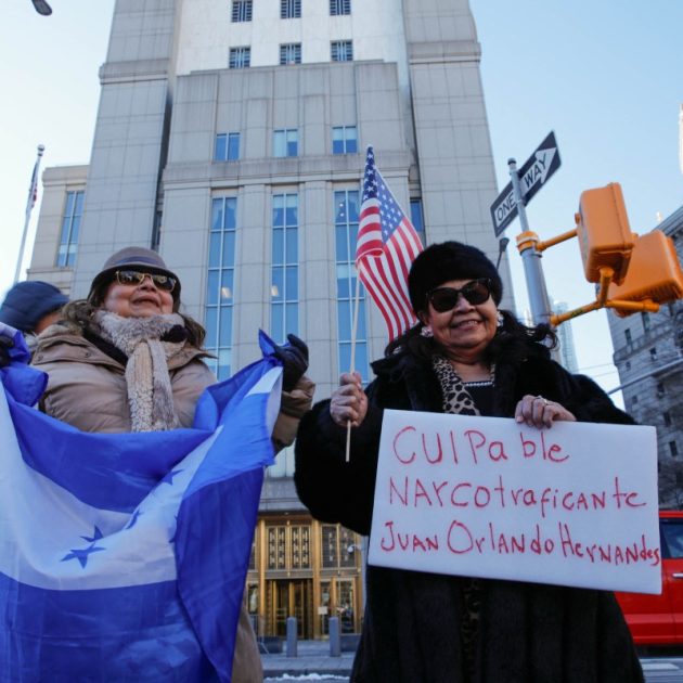People protest outside federal court in Manhattan as the drug trafficking trial begins for former President of Honduras Juan Orlando Hernandez on February 20, 2024, in New York City. - Hernandez was extradited to the US on drug charges in 2022, accused of facilitating the smuggling of 500 tons of cocaine in exchange for millions of dollars in bribes. (Photo by KENA BETANCUR / AFP)