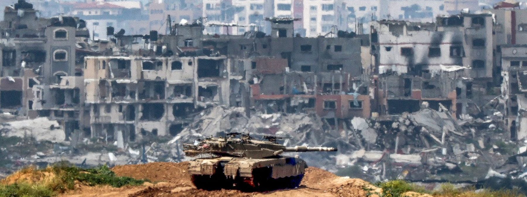 This picture taken from Israel's southern border with the Gaza Strip shows Israeli army battle tank at a position along the border with the Palestinian territory on March 19, 2024, amid the ongoing conflict between Israel and the militant group Hamas. (Photo by JACK GUEZ / AFP)