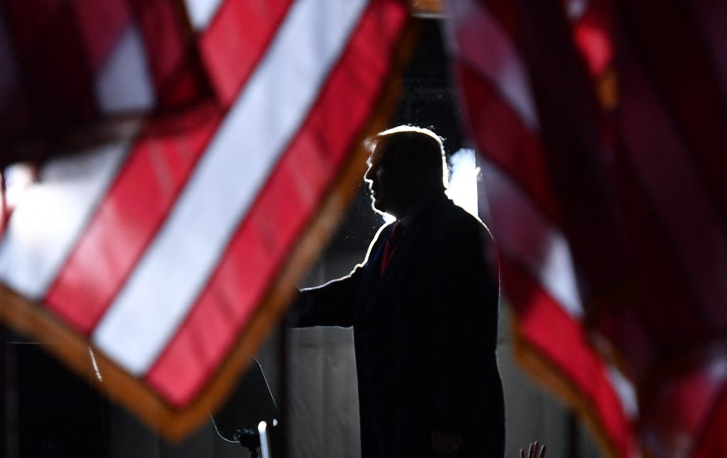US President Donald Trump is seen behind US flags as he speaks to supporters at a "Great American Comeback" event at Central Wisconsin Airport in Mosinee, Wisconsin, on September 17, 2020. (Photo by MANDEL NGAN / AFP)