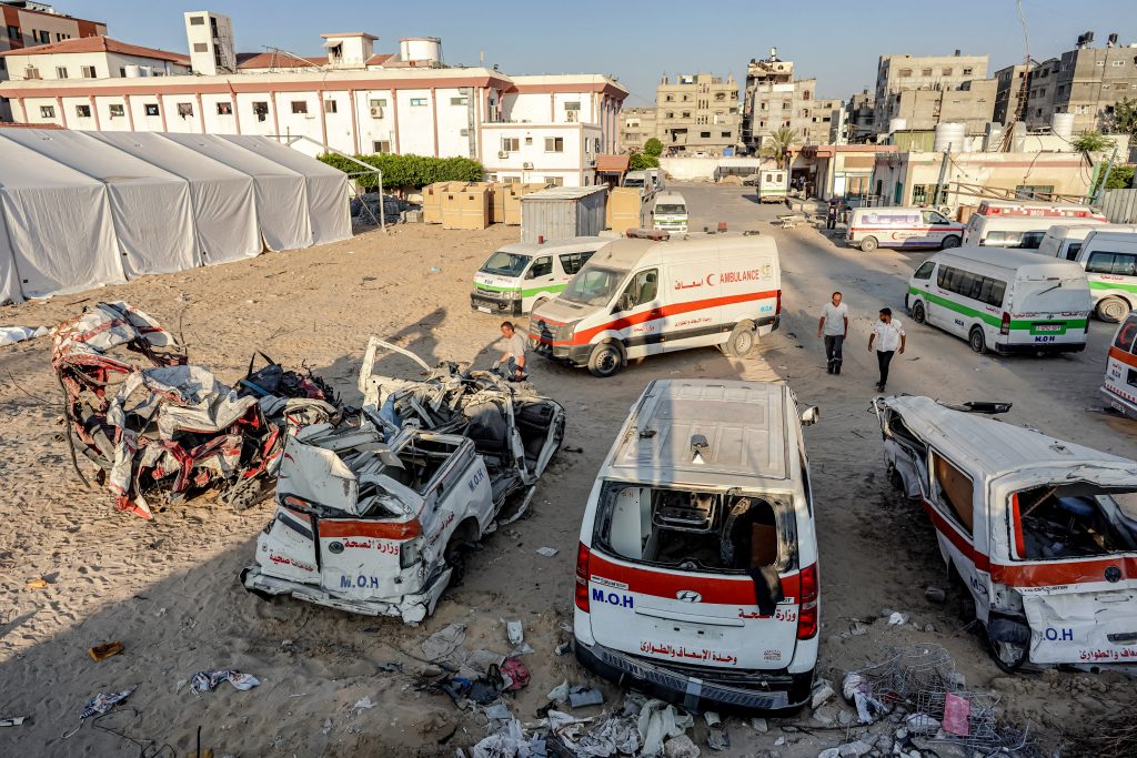 Palestinian paramedics inspect destroyed ambulances at the scene of bombardment in Khan Yunis in the southern Gaza Strip on July 16, 2024 amid the ongoing conflict in the Palestinian territory between Israel and Hamas. (Photo by Bashar TALEB / AFP)