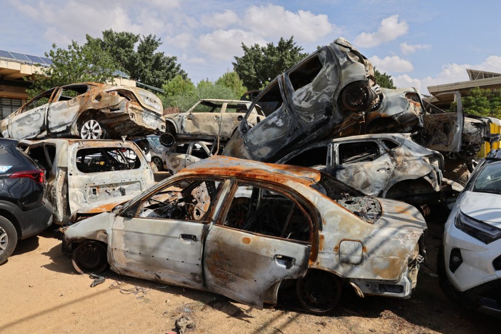 A picture taken on October 17, 2023 shows a pile of damaged and burnt vehicles in the southern Israeli city of Sderot, following the October 7 attack by Gaza-based Hamas militants. US President Joe Biden will visit Israel on October 18, in a show of "ironclad" support as Washington tries to prevent the escalating Gaza war against Hamas from spilling over into a regional conflict. (Photo by Jack Guez / AFP)