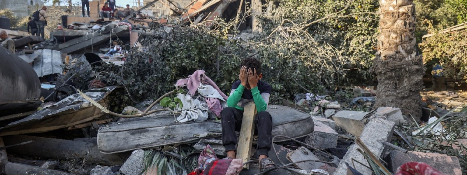 A boy reacts sitting amid the rubble of a house destroyed in an Israeli strike in Nuseirat, in the central Gaza Strip, on October 29, 2025. Gaza's civil defence agency said on October 29 that overnight air strikes killed at least 50 people in the Palestinian territory, as the Israeli military hit a string of targets after an attack that left a soldier dead. Israel began carrying out air strikes on October 28 after accusing Hamas of attacking Israeli troops in Gaza and violating the truce. (Photo by Eyad BABA / AFP)