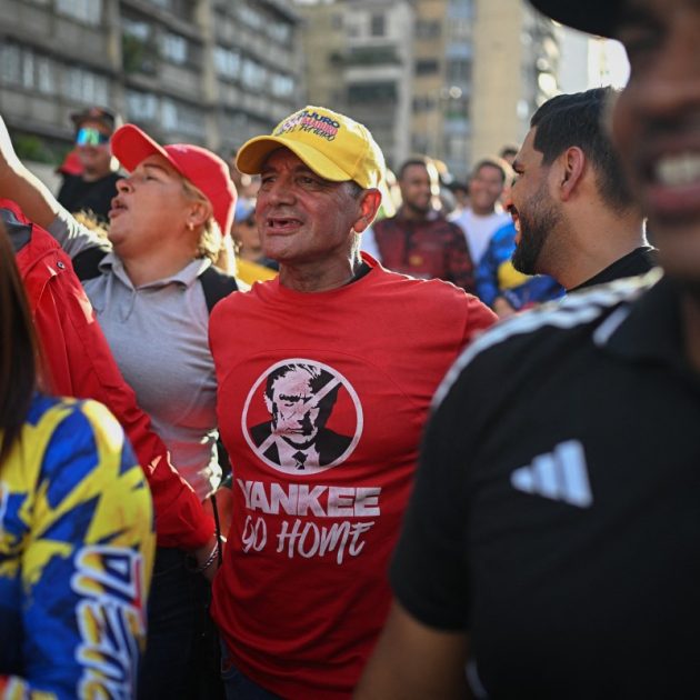 A supporter of Venezuelan President Nicolas Maduro wearing a t-shirt depicting US President Donald Trump and the slogan "Yankee go home" takes part in a rally against US military activity in the Caribbean, in Caracas on October 30, 2025. A US guided-missile destroyer that docked for four days in Trinidad and Tobago, within firing range of mainland Venezuela -- which called its presence a "provocation" -- departed as scheduled on Thursday, AFP witnessed. (Photo by Federico PARRA / AFP)
