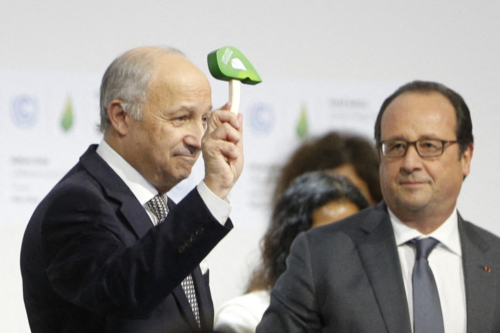 Foreign Affairs Minister and President-designate of COP21 Laurent Fabius (L) waves the official gavel of the COP 21 Climate Conference, as France's President Francois Hollande looks on, after adoption of a historic global warming pact at the COP21 Climate Conference in Le Bourget, north of Paris, on December 12, 2015. Envoys from 195 nations on December 12 adopted to cheers and tears a historic accord to stop global warming, which threatens humanity with rising seas and worsening droughts, floods and storms. AFP PHOTO / FRANCOIS GUILLOT (Photo by FRANCOIS GUILLOT / AFP)