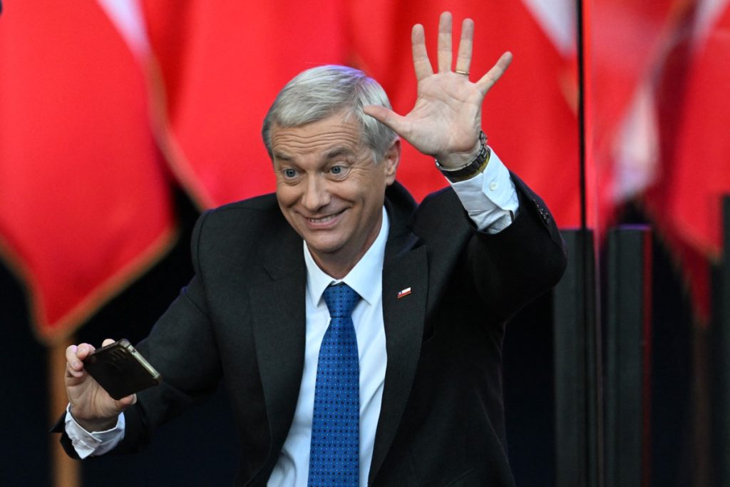 Chile's presidential candidate Jose Antonio Kast of the Republican Party waves to supporters during his closing campaign rally in Temuco, Chile on December 11, 2025. The second round of the Chilean presidential election on December 14 will pit two candidates against each other who are diametrically opposed: Jeannette Jara, the representative of a broad left-wing coalition with modest origins, and the far-right leader Jose Antonio Kast, an ultraconservative Catholic determined to massively expel undocumented migrants. (Photo by EITAN ABRAMOVICH / AFP)
