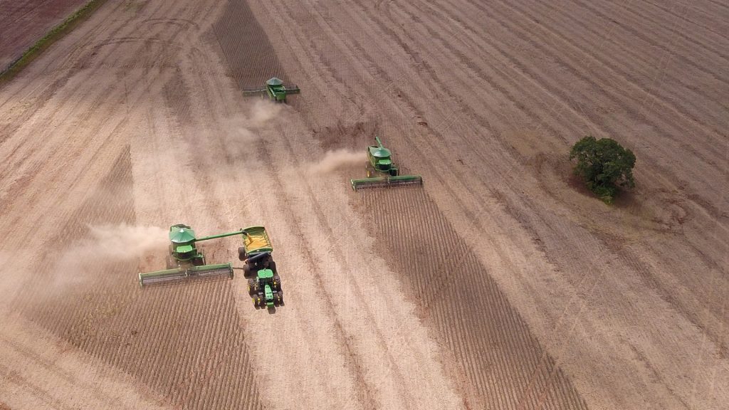 Aerial view of workers harvesting soybeans at one of the plots of the Bom Jardim Lagoano farm in the municipality of Montividiu, Goias State, Brazil, taken on January 22, 2024. The use of biopesticides is an incipient practice in Brazil, an agricultural giant that has relied heavily on GM crops and chemical pesticides, of which it is the largest global consumer. In 2021, it consumed 719,507 tons, 20% of the total traded in the world, according to FAO, the UN agriculture agency. (Photo by Sergio Lima / AFP)