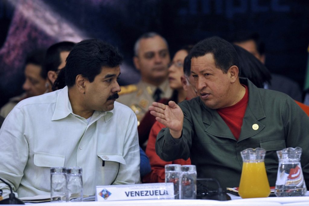 (FILES) Venezuela's President Hugo Chavez (R) talks with his Foreign Affairs Minister Nicolas Maduro during the closing ceremony of the Climate Summit in Tiquipaya 12 km from Cochabamba, Bolivia on April 22, 2010. President Donald Trump said on January 3, 2026, that US forces had captured Venezuelan leader Nicolas Maduro after launching a "large scale strike" on the South American country. "The United States of America has successfully carried out a large scale strike against Venezuela and its leader, President Nicolas Maduro, who has been, along with his wife, captured and flown out of the Country," Trump said on Truth Social. (Photo by AIZAR RALDES / AFP)