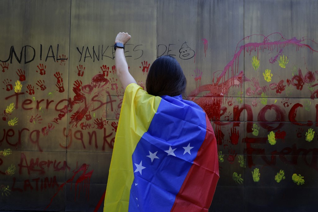 A woman demonstrates outside the U.S. Embassy in Mexico City, Mexico, on January 3, 2026, protesting the attack and military intervention in Venezuela that occurs in the early hours of the day. (Photo by Gerardo Vieyra/NurPhoto) (Photo by Gerardo Vieyra / NurPhoto via AFP)