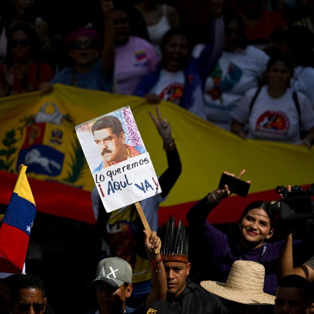 A demonstrator holds a picture of ousted Venezuela's President Nicolas Maduro during a rally to support him and his wife Cilia Flores in Caracas on January 6, 2026. US forces killed 55 Venezuelan and Cuban military personnel during their stunning raid to capture Nicolas Maduro, tolls published by Caracas and Havana showed on January 6. (Photo by Federico PARRA / AFP)