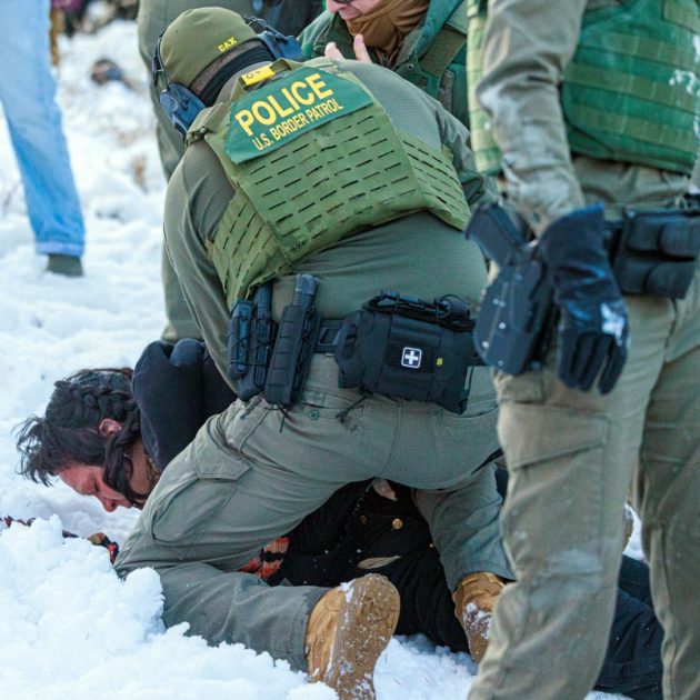 US Border Patrol agents detain a person near Roosevelt High School during dismissal time as federal immigration enforcement actions sparked protests in Minneapolis, Minnesota, on January 7, 2026. An immigration officer in Minneapolis shot dead a woman Wednesday, triggering outrage from local leaders even as US President Donald Trump claimed the officer acted in self-defense. Minneapolis Mayor Jacob Frey deemed the government's allegation that the woman was attacking federal agents "bullshit," and called on Immigration and Customs Enforcement (ICE) officers conducting a second day of mass raids to leave Minneapolis. (Photo by Kerem YUCEL / AFP)