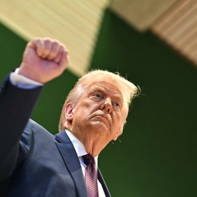US President Donald Trump rises his fist after the "Board of Peace" meeting during the World Economic Forum (WEF) annual meeting in Davos on January 22, 2026. US President Donald Trump will show off his new "Board of Peace" at Davos on January 22, 2026 burnishing his claim to be a peacemaker a day after backing off his own threats against Greenland. Originally meant to oversee the rebuilding of Gaza after the war between Hamas and Israel, the board's charter does not limit its role to the Strip, and has sparked concerns that Trump wants it to rival the United Nations. (Photo by Fabrice COFFRINI / AFP)