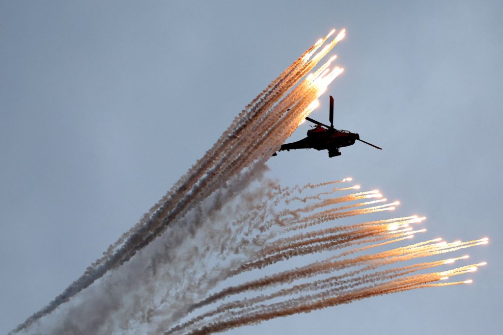 A South Korean army Apache helicopter fires flares during a celebration to mark 76th anniversary of Korea Armed Forces Day in Seongnam on October 1, 2024. (Photo by KIM HONG-JI / POOL / AFP)