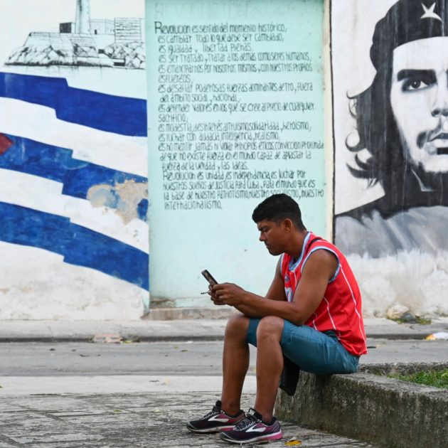 A man uses his mobile phone during the third day of a massive power outage in Havana on October 20, 2024. Hurricane Oscar landed in a locality in Baracoa, in the east of Cuba, when the island prepares for its third night of a blackout, which the authorities intended to resolve without success. (Photo by YAMIL LAGE / AFP)