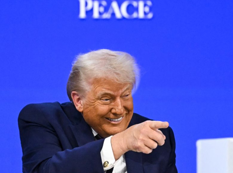 US President Donald Trump gestures as he speaks at the "Board of Peace" meeting during the World Economic Forum (WEF) annual meeting in Davos on January 22, 2026. US President Donald Trump will show off his new "Board of Peace" at Davos on January 22, 2026 burnishing his claim to be a peacemaker a day after backing off his own threats against Greenland. Originally meant to oversee the rebuilding of Gaza after the war between Hamas and Israel, the board's charter does not limit its role to the Strip, and has sparked concerns that Trump wants it to rival the United Nations. (Photo by Fabrice COFFRINI / AFP)