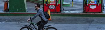 A man rides his bicycle past an empty gas station in Havana on February 19, 2026. Faced with a severe energy crisis exacerbated by US sanctions, private companies in Cuba are attempting to import fuel after the island's government agreed to end its monopoly on the sector. (Photo by YAMIL LAGE / AFP)