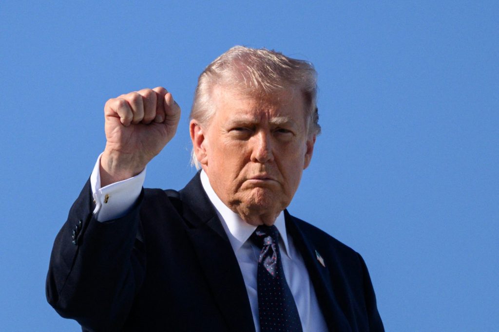 US President Donald Trump gestures as he boards Air Force One before departing Palm Beach International Airport in West Palm Beach, Florida, on March 1, 2026, on his way back to Washington, DC. The United States and Israel launched massive bombardments against Iran and killed its supreme leader on February 28, with attacks ongoing Sunday. The US military on Sunday said three service members have been killed and five seriously wounded in the war against Iran -- the first casualties announced on the US side. (Photo by Mandel NGAN / AFP)