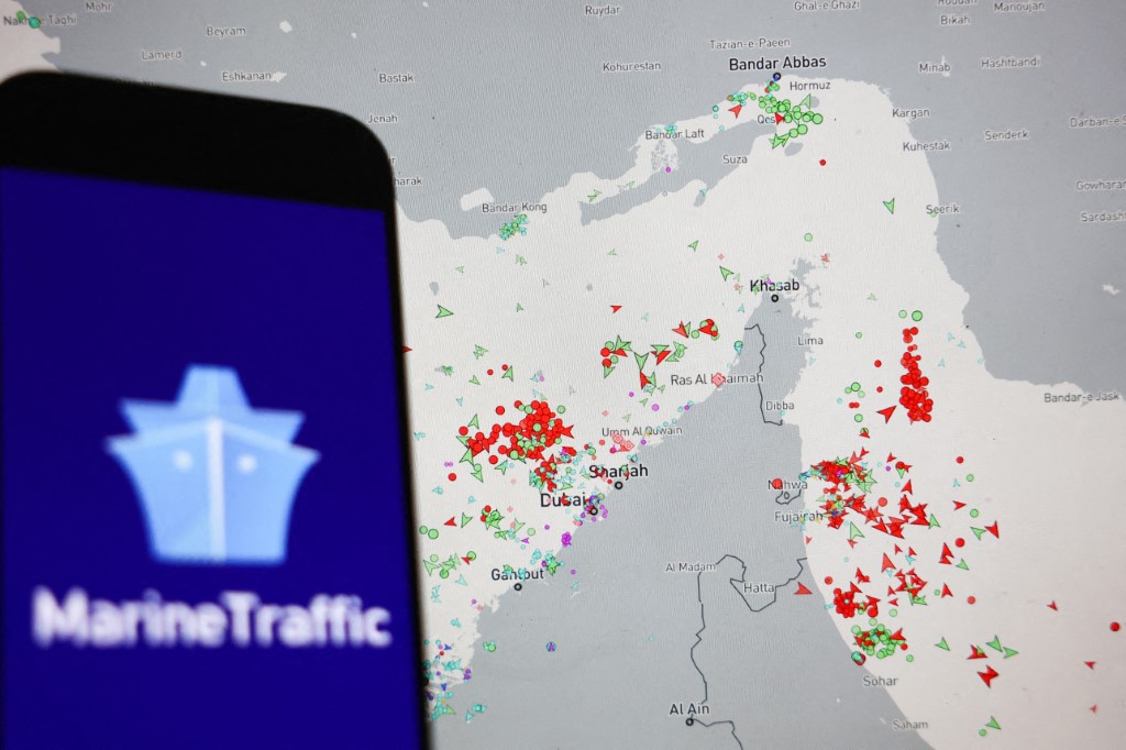MarineTraffic map showing current ships traffic on Strait of Hormuz dislplayed on a laptop screen and MarineTraffic logo displayed on a phone screen are seen in this illustration photo taken in Krakow, Poland on March 5, 2026. (Photo by Jakub Porzycki/NurPhoto) (Photo by Jakub Porzycki / NurPhoto via AFP)