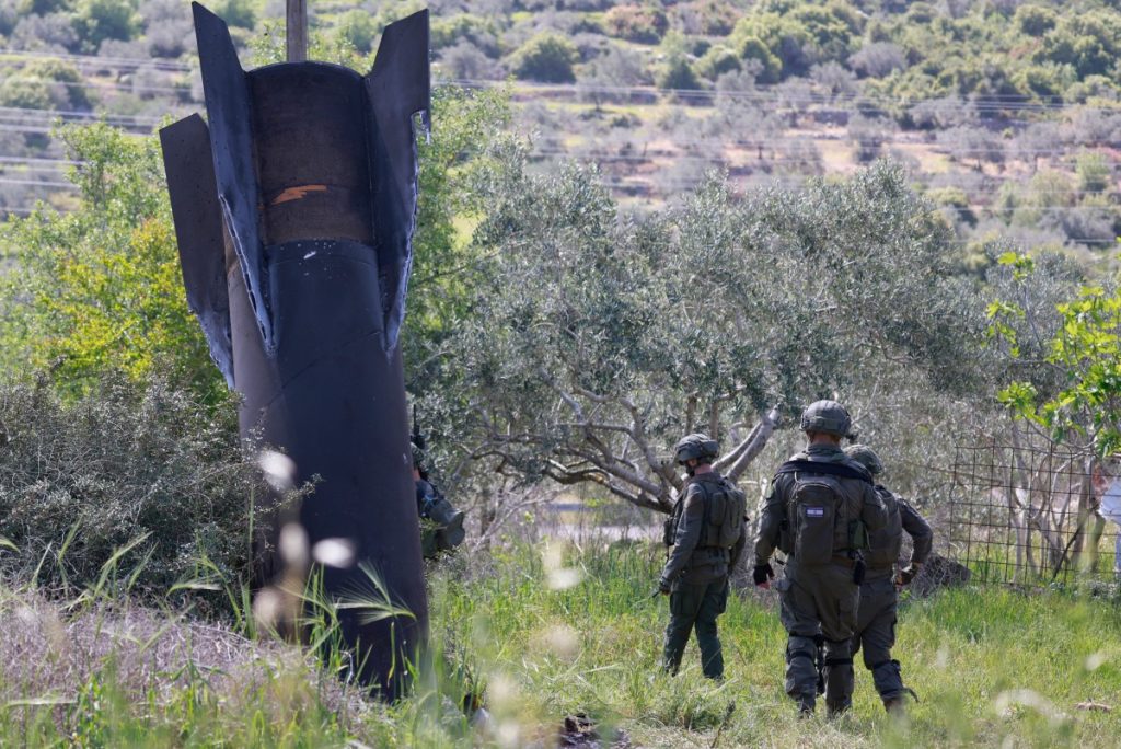 Israeli soldiers check the remnants of an Iranian missile that landed in the Israeli-occupied West Bank village of Hares on March 24, 2026. Since the United States and Israel unleashed strikes on Iran on February 28, war has spread across the Middle East, with casualties reported in countries across the region. (Photo by Jaafar ASHTIYEH / AFP) /