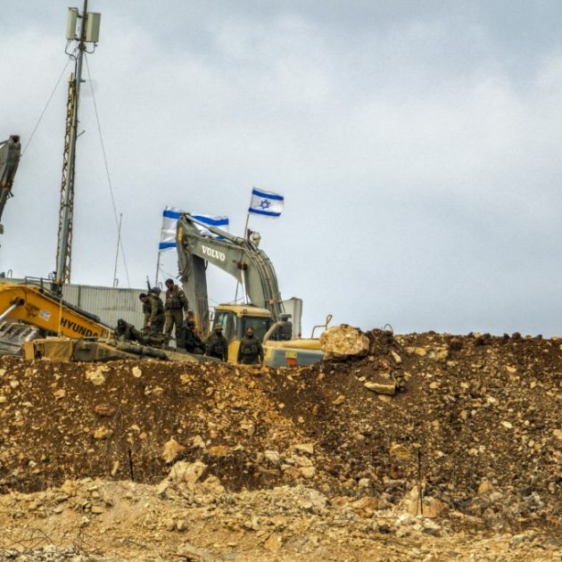 Israeli soldiers take a break from construction work at an illegal Israeli outpost in Houla, southern Lebanon, on July 31, 2025. Positioned directly adjacent to a United Nations facility, the site has seen ongoing expansion activity, including the presence of armored construction vehicles such as a Caterpillar D9 bulldozer. The outpost, which is not officially recognized and lies beyond Israels internationally accepted border, highlights escalating tensions along the Lebanon-Israel frontier. The expansion has drawn condemnation from Lebanese officials and concern from international observers over violations of sovereignty and proximity to UN infrastructure. The buildup underscores the fragile security situation in the area, where incidents along the Blue Line often spark diplomatic and military friction. (Photo by COURTNEY BONNEAU / Middle East Images via AFP)