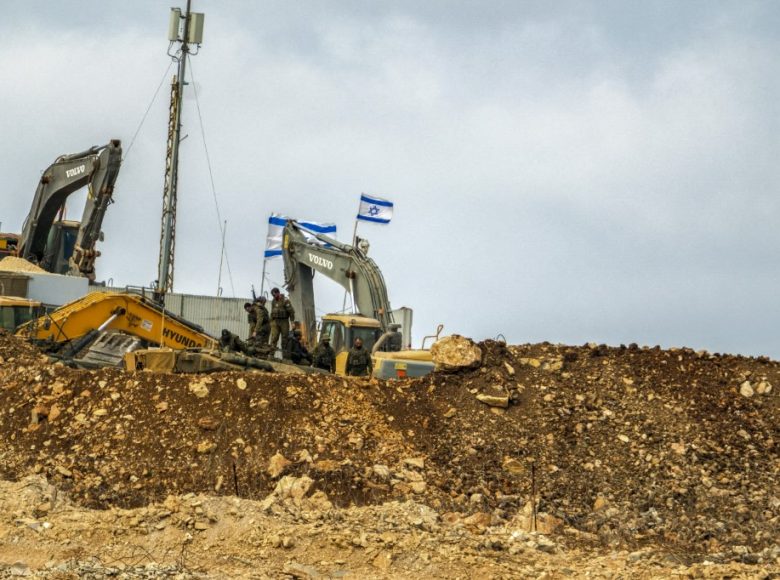 Israeli soldiers take a break from construction work at an illegal Israeli outpost in Houla, southern Lebanon, on July 31, 2025. Positioned directly adjacent to a United Nations facility, the site has seen ongoing expansion activity, including the presence of armored construction vehicles such as a Caterpillar D9 bulldozer. The outpost, which is not officially recognized and lies beyond Israels internationally accepted border, highlights escalating tensions along the Lebanon-Israel frontier. The expansion has drawn condemnation from Lebanese officials and concern from international observers over violations of sovereignty and proximity to UN infrastructure. The buildup underscores the fragile security situation in the area, where incidents along the Blue Line often spark diplomatic and military friction. (Photo by COURTNEY BONNEAU / Middle East Images via AFP)