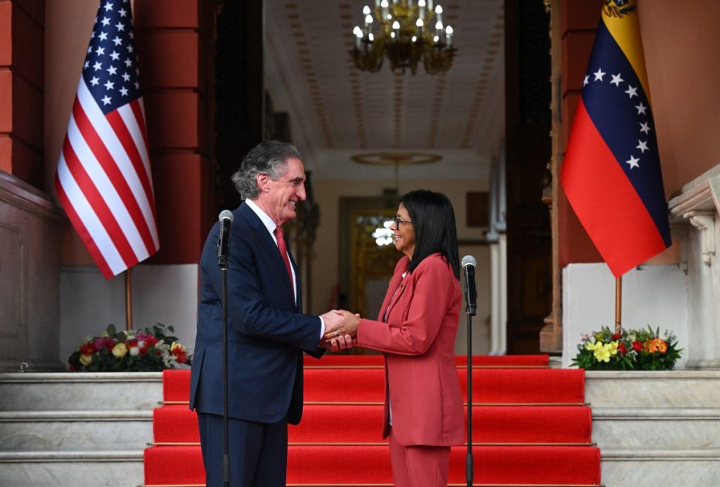 Venezuelas interim president, Delcy Rodriguez, shakes hands with US Interior Secretary Doug Burgum after their meeting at the Miraflores Presidential Palace in Caracas on March 4, 2026. US Interior Secretary Doug Burgum on March 4, 2026, became the latest senior Trump administration official to visit Venezuela, as Washington pushes to ramp up oil and mineral production in the country. (Photo by Federico PARRA / AFP)