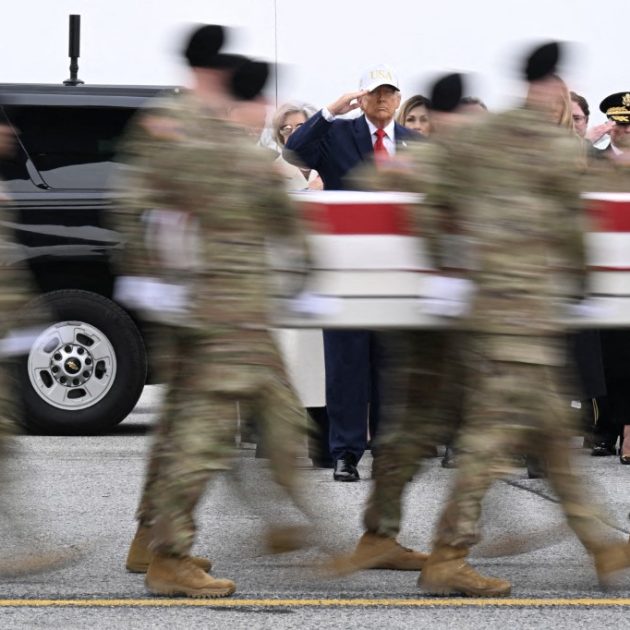 DOVER, DELAWARE - MARCH 07: (L-R) U.S. President Donald Trump and Vice President JD Vance salute as a U.S. Army carry team moves a flag-draped transfer case containing the remains of Sgt. 1st Class Nicole M. Amor at Dover Air Force Base March 07, 2026 in Dover, Delaware. Six soldiers from the 103rd Sustainment Command were killed in action by an Iranian drone strike on March 1 in Port Shuaiba, Kuwait during "Operation Epic Fury". Roberto Schmidt/Getty Images/AFP (Photo by ROBERTO SCHMIDT / GETTY IMAGES NORTH AMERICA / Getty Images via AFP)