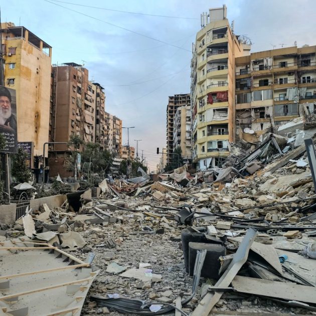 A photograph shows a portrait of Irans slain supreme leader Ayatollah Ali Khamenei and the rubble of a destroyed building at the site of an overnight Israeli airstrike in Beiruts southern suburbs on March 28, 2026. Israel's military renewed its attacks on Beirut's southern suburbs on March 27, saying it was targeting Hezbollah infrastructure, as the Iran-backed group said the foes had clashed directly in the country's south. (Photo by AFP) /