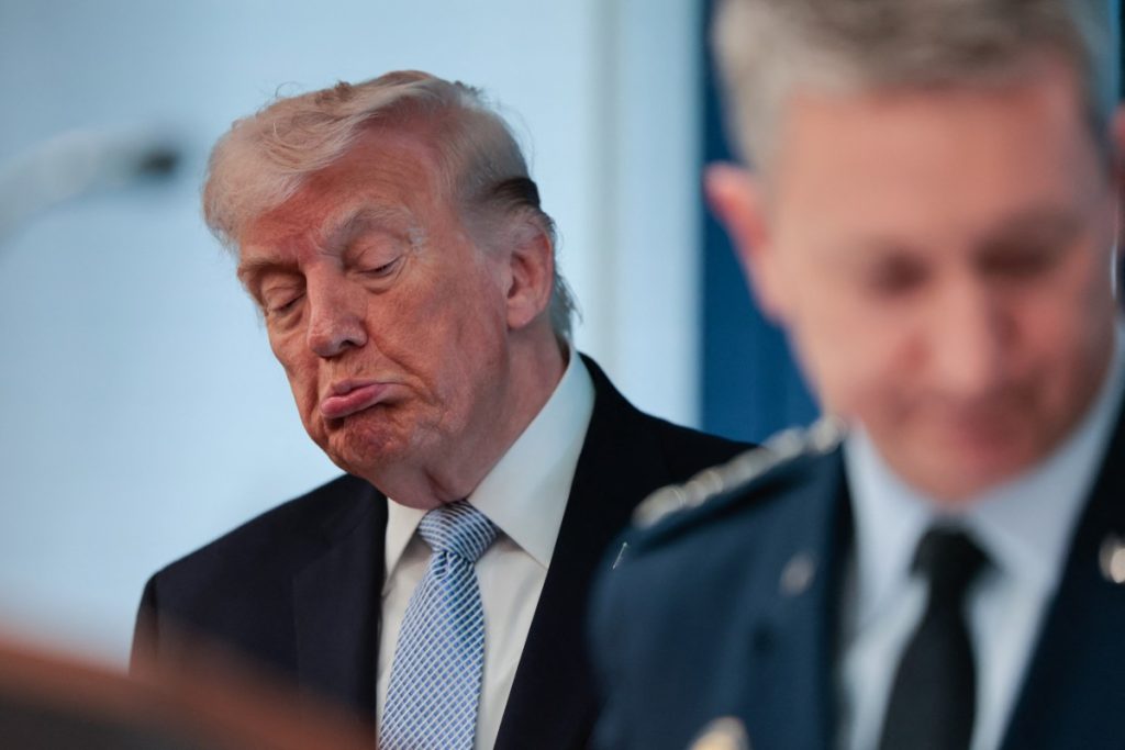 US President Donald Trump (L) looks on as Chairman of the Joint Chiefs of Staff General Dan Caine (R) speaks about the conflict in Iran in the James S. Brady Press Briefing Room of the White House on April 6, 2026, in Washington, DC. (Photo by Kent Nishimura / AFP)