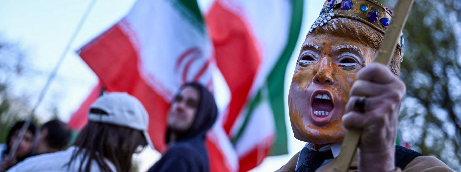 A demonstrator, wearing a mask depicting US President Donald Trump, participates in a protest against US military action in Iran near the White House in Washington, DC, on April 7, 2026. On April 7, US President Donald Trump warned that "a whole civilization will die" in Iran if the country does not heed his midnight cutoff to open the Strait of Hormuz, as Tehran reported US-Israeli attacks on its infrastructure were already underway. (Photo by Brendan SMIALOWSKI / AFP)