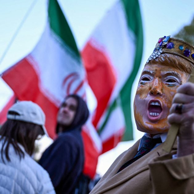 A demonstrator, wearing a mask depicting US President Donald Trump, participates in a protest against US military action in Iran near the White House in Washington, DC, on April 7, 2026. On April 7, US President Donald Trump warned that "a whole civilization will die" in Iran if the country does not heed his midnight cutoff to open the Strait of Hormuz, as Tehran reported US-Israeli attacks on its infrastructure were already underway. (Photo by Brendan SMIALOWSKI / AFP)