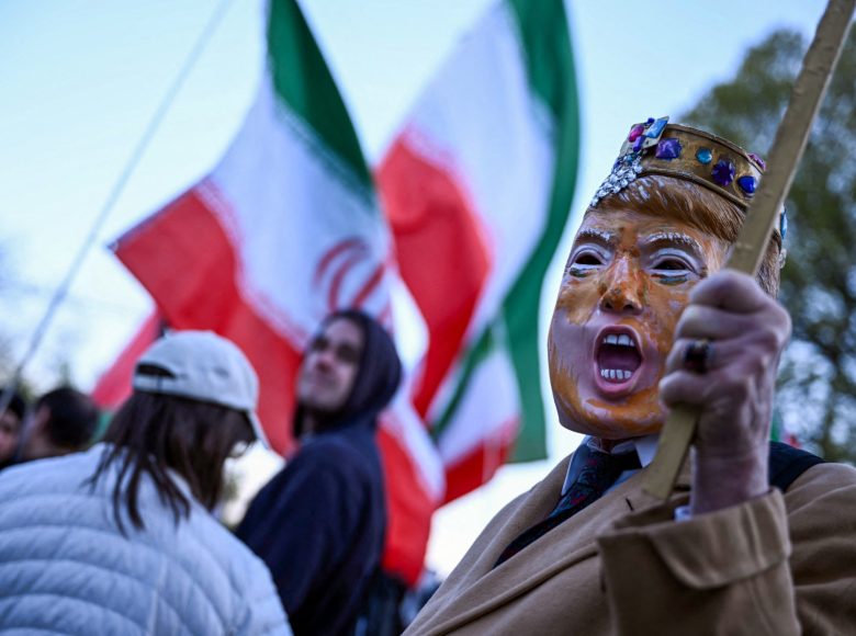 A demonstrator, wearing a mask depicting US President Donald Trump, participates in a protest against US military action in Iran near the White House in Washington, DC, on April 7, 2026. On April 7, US President Donald Trump warned that "a whole civilization will die" in Iran if the country does not heed his midnight cutoff to open the Strait of Hormuz, as Tehran reported US-Israeli attacks on its infrastructure were already underway. (Photo by Brendan SMIALOWSKI / AFP)