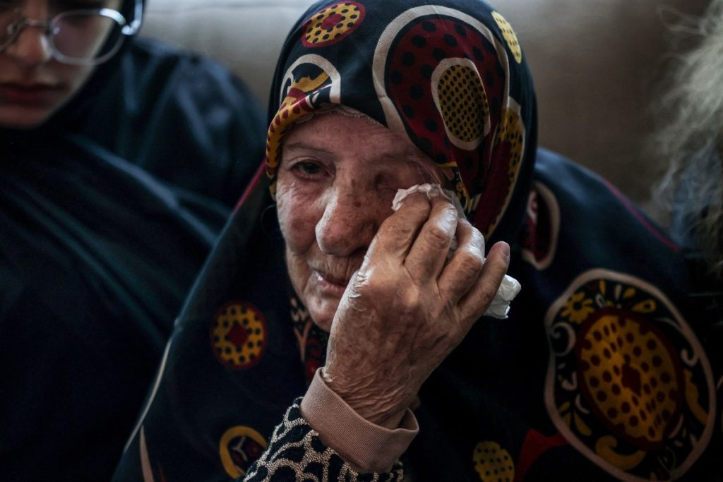 A relative of Hassan Ali Badawi, a paramedic with the Lebanese Red Cross who was killed the previous day in an Israeli airstrike, mourns as the family receives condolences at their home in the Bchamoun area south of Beirut, on April 13, 2026. Lebanon's health ministry said at least six people were killed on April 12 in the south, including a Red Cross paramedic, after "the Israeli enemy directly targeted a Lebanese Red Cross ambulance team". (Photo by Anwar AMRO / AFP)