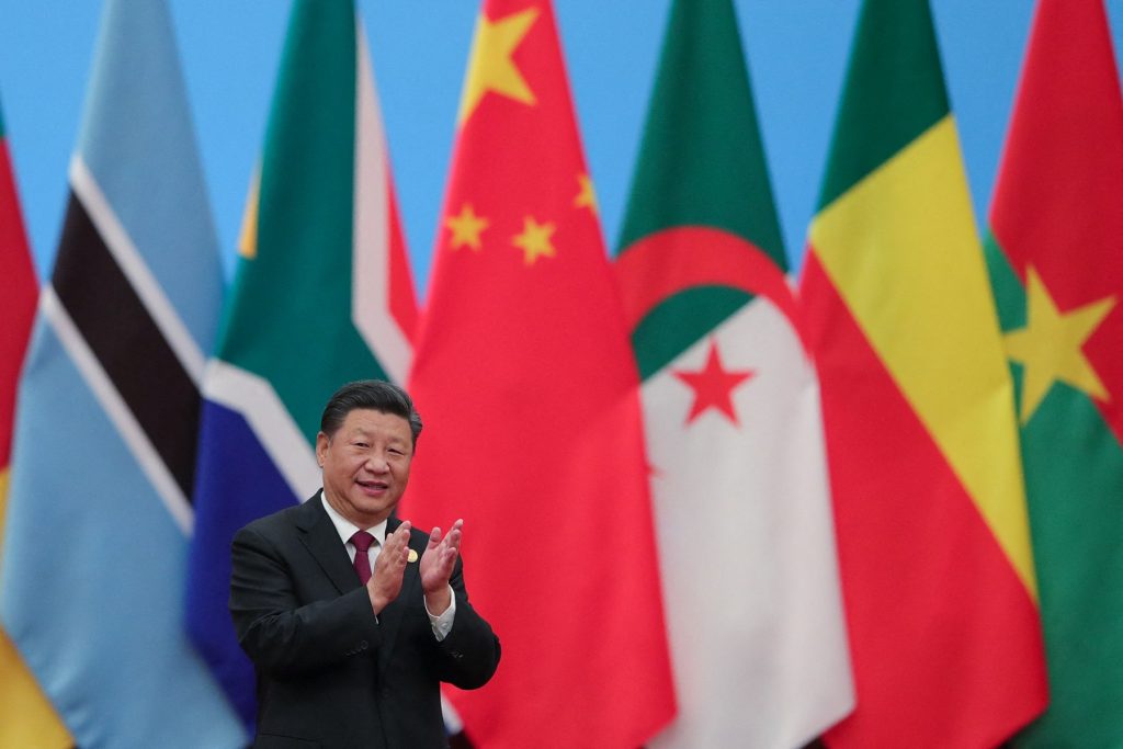 China's President Xi Jinping applauding as he attends the Forum On China-Africa Cooperation - Round Table Conference at the Great Hall of the People in Beijing on September 4, 2018. (Photo by Lintao Zhang / POOL / AFP)