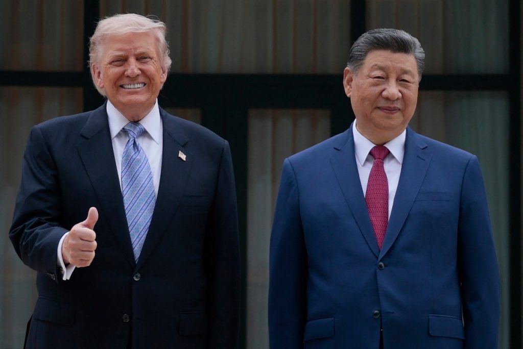 US President Donald Trump (L) poses for photos with Chinas President Xi Jinping during a visit to Zhongnanhai Garden in Beijing on May 15, 2026. (Photo by Evan Vucci / POOL / AFP)