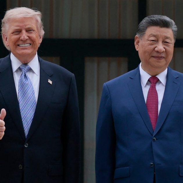 US President Donald Trump (L) poses for photos with Chinas President Xi Jinping during a visit to Zhongnanhai Garden in Beijing on May 15, 2026. (Photo by Evan Vucci / POOL / AFP)