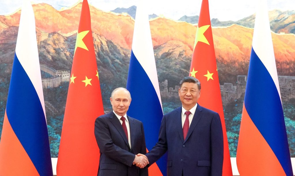 In this pool photograph distributed by the Russian state agency Sputnik, Russia's President Vladimir Putin (L) shakes hands with China's President Xi Jinping during a meeting in Beijing on May 20, 2026. (Photo by Maxim Stulov / POOL / AFP)