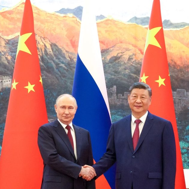 In this pool photograph distributed by the Russian state agency Sputnik, Russia's President Vladimir Putin (L) shakes hands with China's President Xi Jinping during a meeting in Beijing on May 20, 2026. (Photo by Maxim Stulov / POOL / AFP)